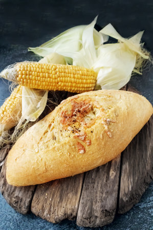 Fresh cornbread and corn grains on the table. Food grain crisis concept. Top view. Copy space.の写真素材