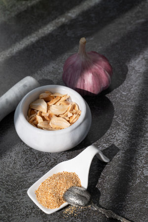 Dried garlic, dried garlic powder and garlic cloves. Dried garlic granules. selective focus. Rustic style.の写真素材