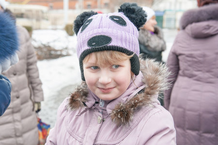 Kolomna, Moscow region, Russia, February 22, 2015. The celebration of Maslenitsa at the temple. A 13-year-old girl in a funny hatのeditorial素材
