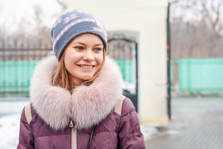 Kolomna, Moscow region. Russia February 22, 2015. beautiful young woman in a knitted hat and outside in winter. The Russian beauty smiles and looks at the cameraのeditorial素材