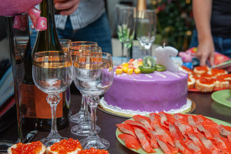 Large cake and sandwiches with caviar for a holiday. Table decoration with cake and sandwiches with...