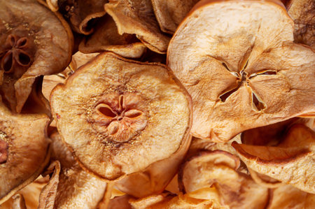 dried pear chips, background. pear dried in a dehydrator for preparing food and drinks. pear chips on a light background. It's edible.の写真素材