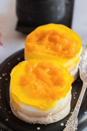 dessert made from yogurt and jelly. Orange peach and sponge cake layered dessert idea, yogurt and...