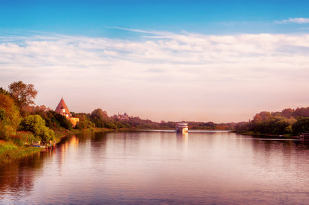 Beautiful morning landscape of the banks of the Volkhov River. In the distance is a cruise ship and a medieval fortress.のeditorial素材