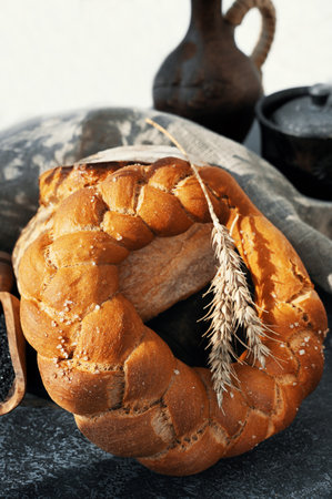 Assorted bread made from wheat and rye sourdough. Rich challah and round rye bread with black salt....