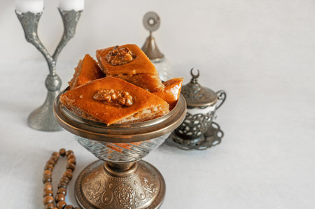 Arabian Baklava with nuts and honey on white background, top view. Ramadan dessert - fresh assorted nut baklava. Copy spaceの写真素材
