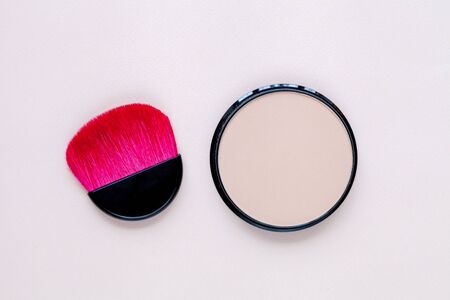 Powder with pink brush on light pastel background, top viewの写真素材