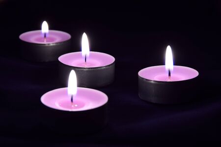 Romantic card with beautiful violet candles in the darknessの写真素材