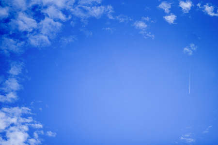 Summer blue sky with white clouds. Blue background with place for text.の写真素材
