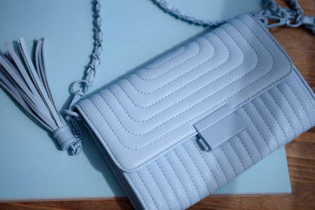 Blue small quilted bag close-up on a blue background. View from aboveの写真素材