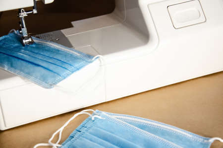Sewing machine made face medical mask during coronavirus pandemic. Detail on sewing machine....