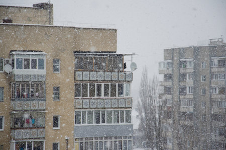 Snowfall in the city. Blizzard covered houses and streets with snow. Bad weather conditions. Beautiful snowy winter in a residential area of ââUkraine.の写真素材