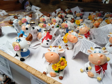 Lutsk, Ukraine - December 10 2020. Ceramic souvenirs symbol of 2021 White Metal Bull. Rack with Christmas decorations in the Epicenter shopping center. Cow as symbol of the New year 2021. Celebration concept.のeditorial素材