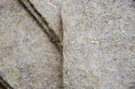 Selective focus on structure of linen seedling mats. Texture of substrate for growing microgreens. Organic substrate for sowing green seeds. Pile of folded linen fiber rugs.の写真素材