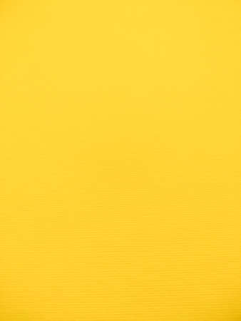 Texture of yellow watercolor paper. Surface of the drawing paper. Wall with yellow gradient with copy space.の写真素材
