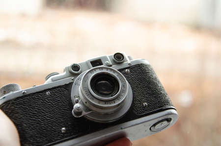 Kiev, Ukraine - March 28, 2021. Soviet vintage camera Zorky-S with Industar-22 lens on blurred...