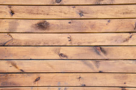 Close-up wooden surface. Old fence made of wooden beams. Grunge wooden texture with horizontal...