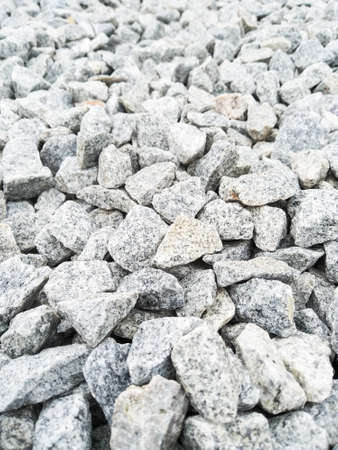 Gray gravel background with copy space. The natural texture of gray stones. Rough stone background. Grunge backdrop with textured pebbles.の写真素材