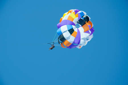 Konakli, Turkey - June 5, 2021. People ride on parachute tied to boat. Water sports in Turkey. Popular entertainment is parasailing. Extreme water sport on summer vacation.のeditorial素材