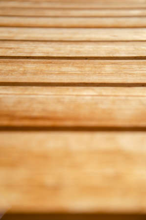 Selective focus of texture wooden background. Surface of light brown wooden horizontal boards. House...