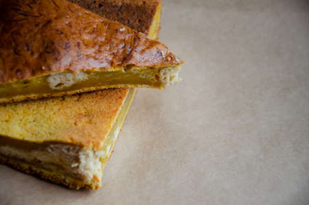 Concept homemade fall baking with pumpkin and food ingredients. Cooking pumpkin pie. Texture of sliced pumpkin pie with copy space. Step by step instructions. Step 8.の写真素材