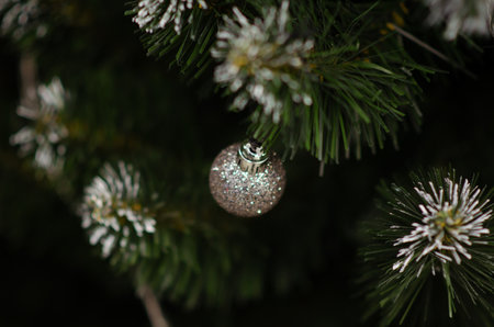 Traditional artificial Christmas tree with silver ball ornament in background with copy space. Soft focus Christmas decorations. Seasonal winter holiday. New year concept.の写真素材