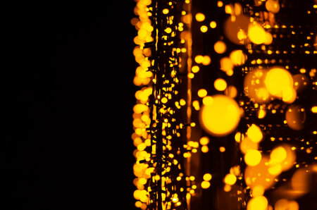 Abstract background. Christmas lights on the city street. New Year decorations, selective focus....