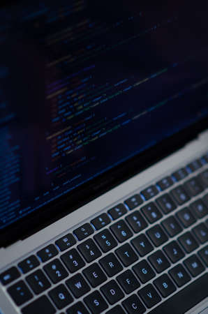 London, UK - January 12, 2022. Caucasian man uses MacBook Air M1. Programmer is coding on latest Apple laptop. Concept of modern popular professions. vertical photo.のeditorial素材