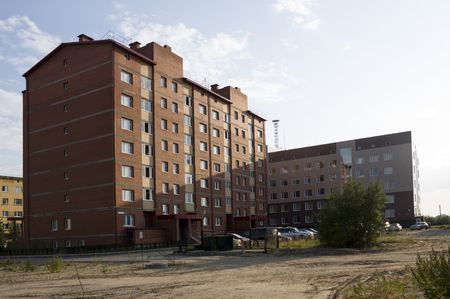 Modern multi-storeyed buildings with telecommunications tower behindの写真素材