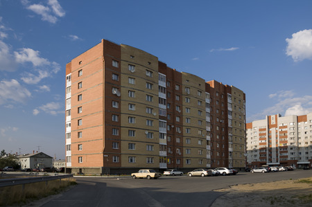 Modern multi-storeyed house with flats. It was built from yellow and orange colorの写真素材