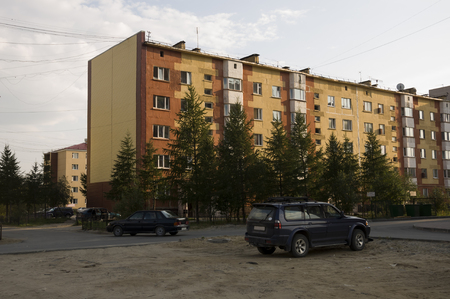 Modern five-storeyed house with flats. It was colored in red, orange and white colors 3の写真素材