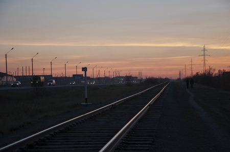 New Urengoy, YaNAO, North of Russia. September 30, 2017. Sundown and sunrises. Railroad in the summer. Dark silhouettes of people.のeditorial素材