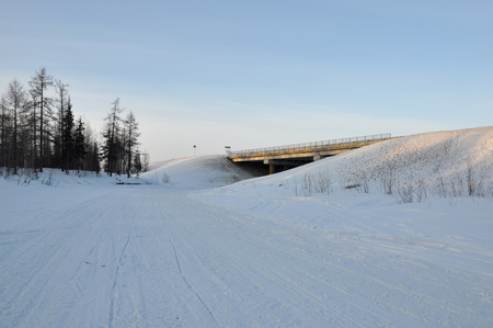 Winter bridge over the frosty and snowy riverの写真素材