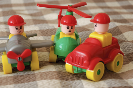 Children toys. Multi-colored plastic constructor with blocks for building houses and cars, plain, bus with figures of peopleの写真素材