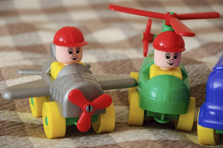 Children toys. Multi-colored plastic constructor with blocks for building houses and cars, plain, bus with figures of peopleの写真素材