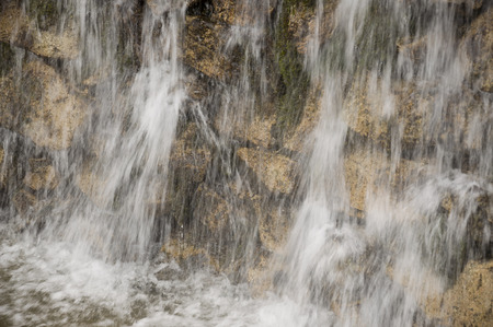 Mineral spring. Stream in the SPA. Curative water. Resort. Waterfalls. Summer. Clear and fresh water on the stone wallの写真素材