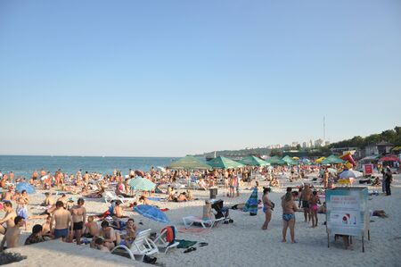 Odessa, South of Ukraine, Coast of the Black Sea, Langeron beach, June 28, 2018. People are resting at the water. Mainly cloudy weather. Pier dockのeditorial素材