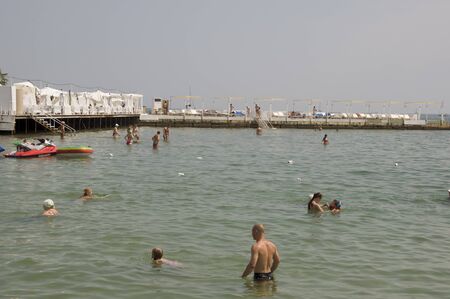 Odessa, South of Ukraine, Coast of the Black Sea, beach Ibiza club, June 28, 2018. People are resting at the water. Mainly cloudy weather. Pier dockのeditorial素材