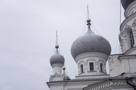 Christian orthodox white gold with gold crosses. Calm gray sky aboveの写真素材