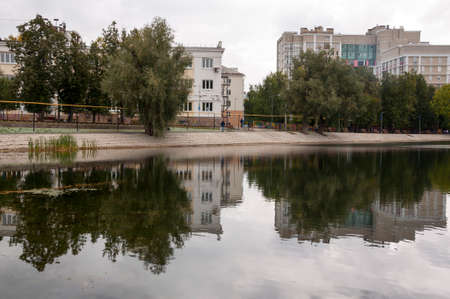 Ufa, Russia, st. Lenina, Park of Culture and Leisure named after Ivan Yakutov. May 11, 2022. Modern buildings near the large lake. green trees aroundのeditorial素材