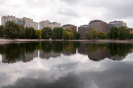 Ufa, Russia, st. Lenina, Park of Culture and Leisure named after Ivan Yakutov. May 11, 2022. Modern buildings near the large lake. green trees aroundのeditorial素材