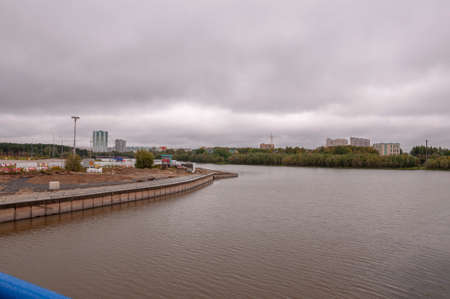 Surgut, Russia, 12 Griboyedov Street, May 11, 2022. Modern buildings and view of the embankment of the Ob riverのeditorial素材