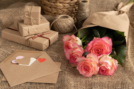 Pink roses, brown paper gift boxes, paper heart, declaration of love letterの写真素材