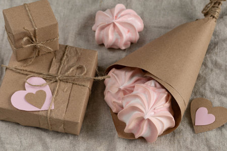Gift in a brown craft box with a paper heart, marshmallow meringue for loversの写真素材