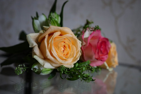 close up of beautiful bridal bouquet with roses and green leaves