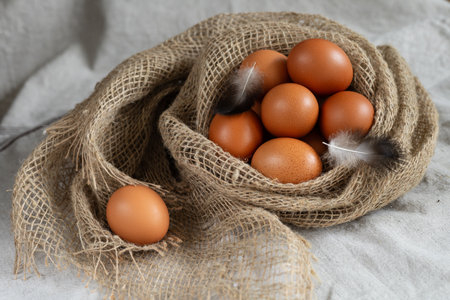 Eggs in a burlap bag on a white background.の写真素材