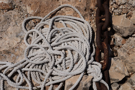 Close up of a mooring rope tied to a metal chain
