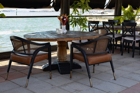 Tables and chairs in a restaurant on the bank of the river