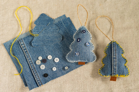 Handmade jean clothes with buttons on canvas background