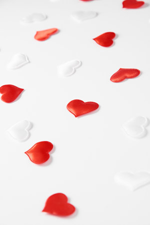 Red and white silk hearts isolated on white background. Valentines day or Wedding romantic concept, top view, copy space, flat layの写真素材